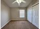 Cozy bedroom featuring a ceiling fan, window blinds, and a spacious closet at 703 Tartan Loop, Lake Wales, FL 33853