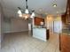 Open concept kitchen with granite countertops and convenient breakfast bar at 703 Tartan Loop, Lake Wales, FL 33853