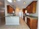 Open kitchen featuring granite countertops, stainless steel appliances, and warm wood cabinets at 703 Tartan Loop, Lake Wales, FL 33853