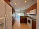 Bright kitchen featuring granite counters, white appliances, and wood cabinetry at 703 Tartan Loop, Lake Wales, FL 33853