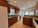 Updated kitchen showcasing granite counters, stainless steel appliances, and wood cabinets at 703 Tartan Loop, Lake Wales, FL 33853