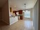 Bright kitchen with granite counters, tile floors, and views to the dining area at 703 Tartan Loop, Lake Wales, FL 33853