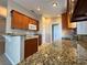 Well-equipped kitchen boasts granite countertops, wooden cabinets, and ample counter space at 703 Tartan Loop, Lake Wales, FL 33853