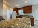 Modern kitchen with granite countertops, ample cabinets, and stainless steel refrigerator at 703 Tartan Loop, Lake Wales, FL 33853