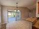 Open-concept kitchen with granite countertops that lead to the adjacent dining area at 703 Tartan Loop, Lake Wales, FL 33853