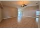 Large living space with tile flooring, neutral walls, and access to the backyard at 703 Tartan Loop, Lake Wales, FL 33853