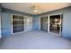 Screened-in patio with blue walls, a ceiling fan and access to the backyard and adjacent rooms via sliding doors at 703 Tartan Loop, Lake Wales, FL 33853