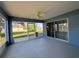 Relaxing patio with a ceiling fan and screened windows, providing a seamless transition to the outdoors at 703 Tartan Loop, Lake Wales, FL 33853
