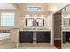 Elegant bathroom featuring dual vanities, granite countertops, and a mirrored closet door for a luxurious experience at 7699 Milano Dr, Orlando, FL 32835