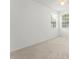 Bright bedroom with neutral carpet and paint, featuring multiple windows at 7699 Milano Dr, Orlando, FL 32835