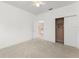 This bedroom includes a ceiling fan, closet, and access to the upstairs hallway at 7699 Milano Dr, Orlando, FL 32835