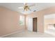 Cozy bedroom featuring a ceiling fan, window, and closet space for storage at 7699 Milano Dr, Orlando, FL 32835