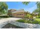 Two-story home featuring a two-car garage, concrete driveway, and manicured landscaping at 7699 Milano Dr, Orlando, FL 32835
