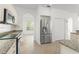 Spacious kitchen featuring stainless steel appliances, granite countertops, and tile flooring at 7699 Milano Dr, Orlando, FL 32835