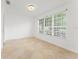Bright, naturally lit living room with neutral tile floors and a large window at 7699 Milano Dr, Orlando, FL 32835