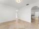 Open living space featuring arched doorways, neutral tile, and a modern light fixture at 7699 Milano Dr, Orlando, FL 32835