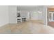 Open-concept living area with bar seating, tile flooring, and access to the outdoor space at 7699 Milano Dr, Orlando, FL 32835