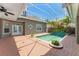 Private screened-in pool area with brick pavers, lush landscaping, and a tranquil water feature at 7699 Milano Dr, Orlando, FL 32835