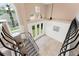 Bright foyer with a view of the backyard from the high staircase at 7699 Milano Dr, Orlando, FL 32835
