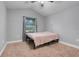 Bedroom features a neutral color palette, a large window, ceiling fan and plush carpeting at 812 Deep Wood Ct, Fruitland Park, FL 34731