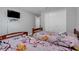 Bright bedroom featuring two beds with colorful linens, closet and TV at 812 Deep Wood Ct, Fruitland Park, FL 34731