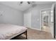 Bedroom with neutral walls, carpet, ceiling fan, and closet near hallway door at 812 Deep Wood Ct, Fruitland Park, FL 34731
