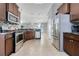 Modern kitchen featuring stainless steel appliances, dark wood cabinets, and tile backsplash at 812 Deep Wood Ct, Fruitland Park, FL 34731