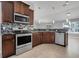 Well-equipped kitchen features stainless steel appliances, granite countertops, and sleek cabinetry at 812 Deep Wood Ct, Fruitland Park, FL 34731