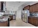 Spacious kitchen with stainless steel appliances, granite countertops, and dark wood cabinets at 812 Deep Wood Ct, Fruitland Park, FL 34731