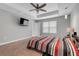 Inviting bedroom features carpet flooring, tray ceiling, a ceiling fan, and natural lighting at 812 Deep Wood Ct, Fruitland Park, FL 34731