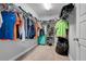Functional walk-in closet with ample storage shelving and hanging space for clothes and accessories at 812 Deep Wood Ct, Fruitland Park, FL 34731