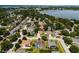 An aerial view shows the neighborhood, showcasing the home with its solar panels and pool at 887 Lancer Cir, Ocoee, FL 34761