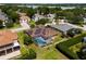 Aerial view of a pool home with solar panels, screened lanai, and meticulously maintained landscaping at 887 Lancer Cir, Ocoee, FL 34761