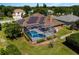 Aerial view of a pool home featuring a screened lanai and solar panels on a neatly manicured lawn at 887 Lancer Cir, Ocoee, FL 34761