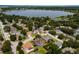 A scenic aerial view showcasing a neighborhood near a lake with lush trees and well-maintained homes at 887 Lancer Cir, Ocoee, FL 34761
