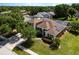 Gorgeous aerial of a home that features solar panels, a screened in pool, and well manicured landscaping at 887 Lancer Cir, Ocoee, FL 34761