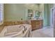 Bathroom with large soaking tub, granite counters, and and sinks at 887 Lancer Cir, Ocoee, FL 34761