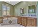 Bathroom with large soaking tub, granite counters, and and sinks at 887 Lancer Cir, Ocoee, FL 34761