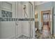Bathroom featuring walk-in shower with glass doors, decorative tile, and brushed nickel fixtures at 887 Lancer Cir, Ocoee, FL 34761