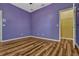View of bedroom with wood-look flooring, light purple walls and a walk-in closet at 887 Lancer Cir, Ocoee, FL 34761