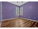 Bedroom featuring hardwood floors, light purple walls, and windows with shutters at 887 Lancer Cir, Ocoee, FL 34761