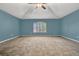 Spacious carpeted bonus room with fan and a large window at 887 Lancer Cir, Ocoee, FL 34761