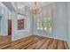 Dining room with wood floors, natural light, and shuttered windows at 887 Lancer Cir, Ocoee, FL 34761