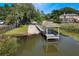 Picturesque waterfront property featuring a private dock and boat ramp with covered seating area and lake views at 887 Lancer Cir, Ocoee, FL 34761
