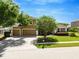 Charming two-story home boasting a well-manicured lawn, mature trees, and a three-car garage at 887 Lancer Cir, Ocoee, FL 34761