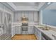 Modern kitchen featuring stainless steel appliances and light gray cabinets at 887 Lancer Cir, Ocoee, FL 34761
