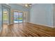 Spacious living room featuring wood floors, vaulted ceilings, and sliding glass doors leading to a pool at 887 Lancer Cir, Ocoee, FL 34761
