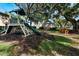 Community playground with slide, swing, and gazebo shaded by mature trees, perfect for outdoor recreation at 887 Lancer Cir, Ocoee, FL 34761