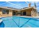 A luxurious screened-in pool with solar panels, multiple doors and windows to access the house at 887 Lancer Cir, Ocoee, FL 34761
