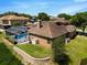 A well-maintained home featuring a screened pool, solar panels, and a brick retaining wall at 887 Lancer Cir, Ocoee, FL 34761